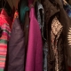 Colourful clothes hanging in a wardrobe