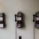 Three historic phones hanging on the wall.